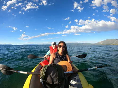Minerva and Samuel with their inflatable canoe paddling across Lake Tahoe, California.