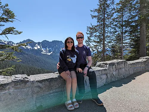 Minerva and Samuel sit in front of Mountain Rainier, Mount Rainier National Park