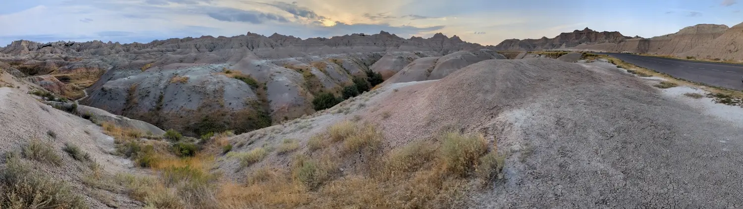 SD 240 Badlands NP Panoramic view of layered, sculpted, and muted-colored mounds along the scenic Highway SD-240 through Badlands National Park.