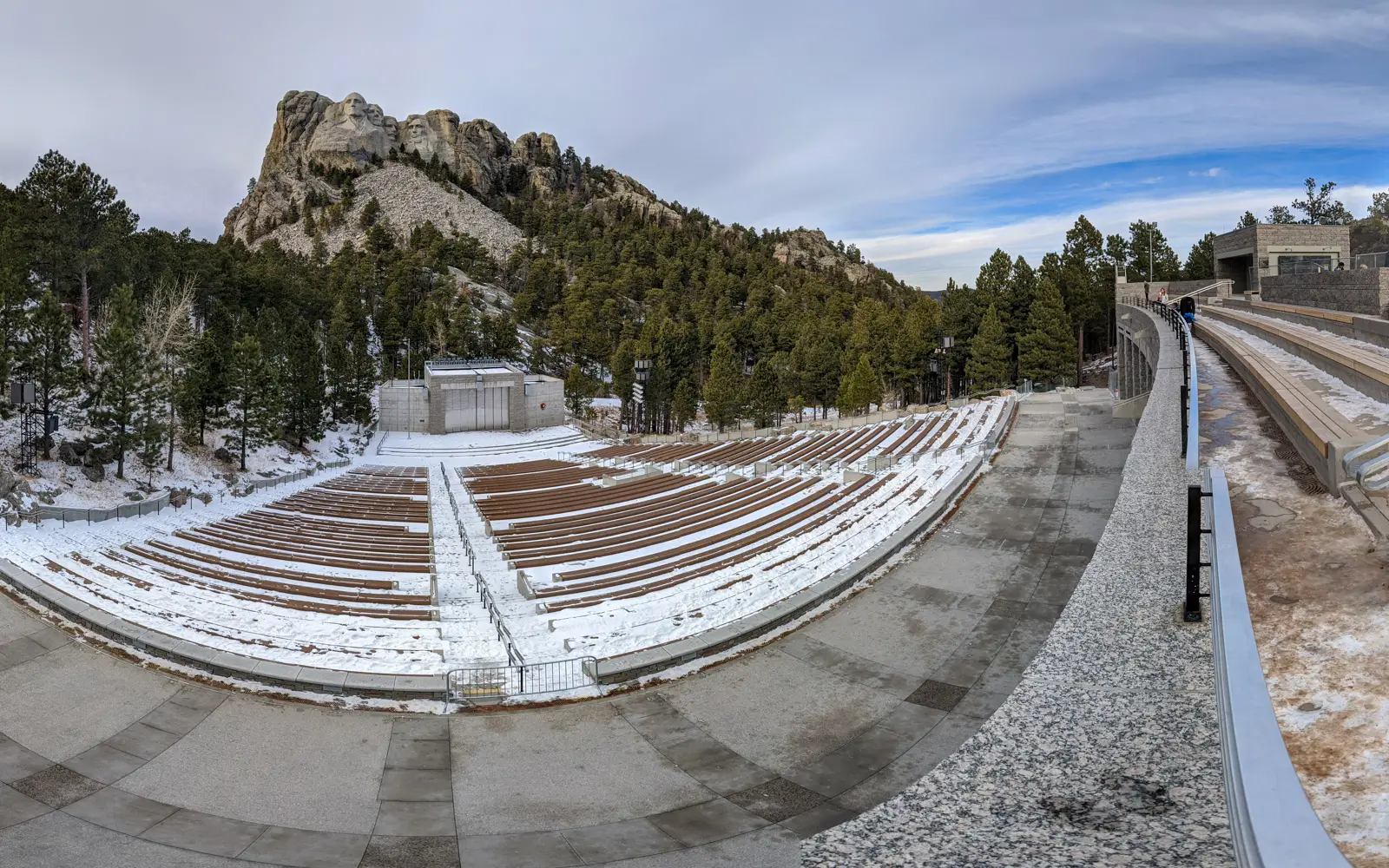 The outdoor amphitheater at Mount Rushmore National Memorial covered in snow during the off-season in January.